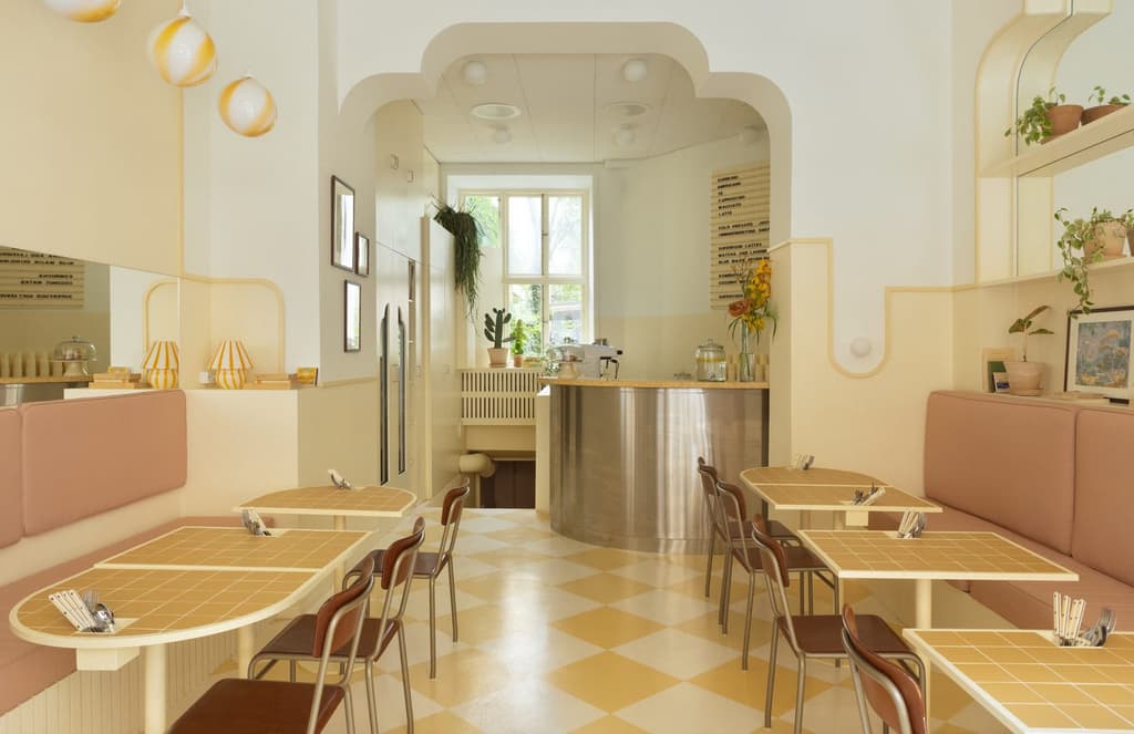 Lemon drop interiors bring a Havana vibe to this Stockholm breakfast spot