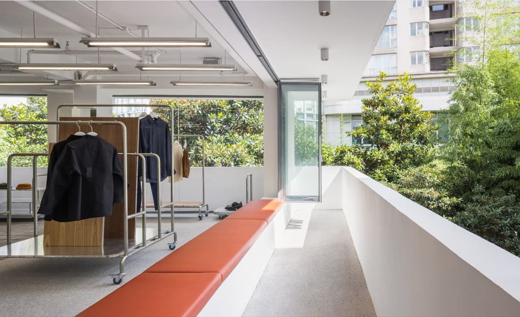 Chinese fashion brand Zuczug has opened a new store in Shanghai's Jing'an neighbourhood, and the centrepiece is a colossal fibreglass staircase that frames the whole space.