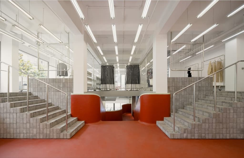 Chinese fashion brand Zuczug has opened a new store in Shanghai's Jing'an neighbourhood, and the centrepiece is a colossal fibreglass staircase that frames the whole space.