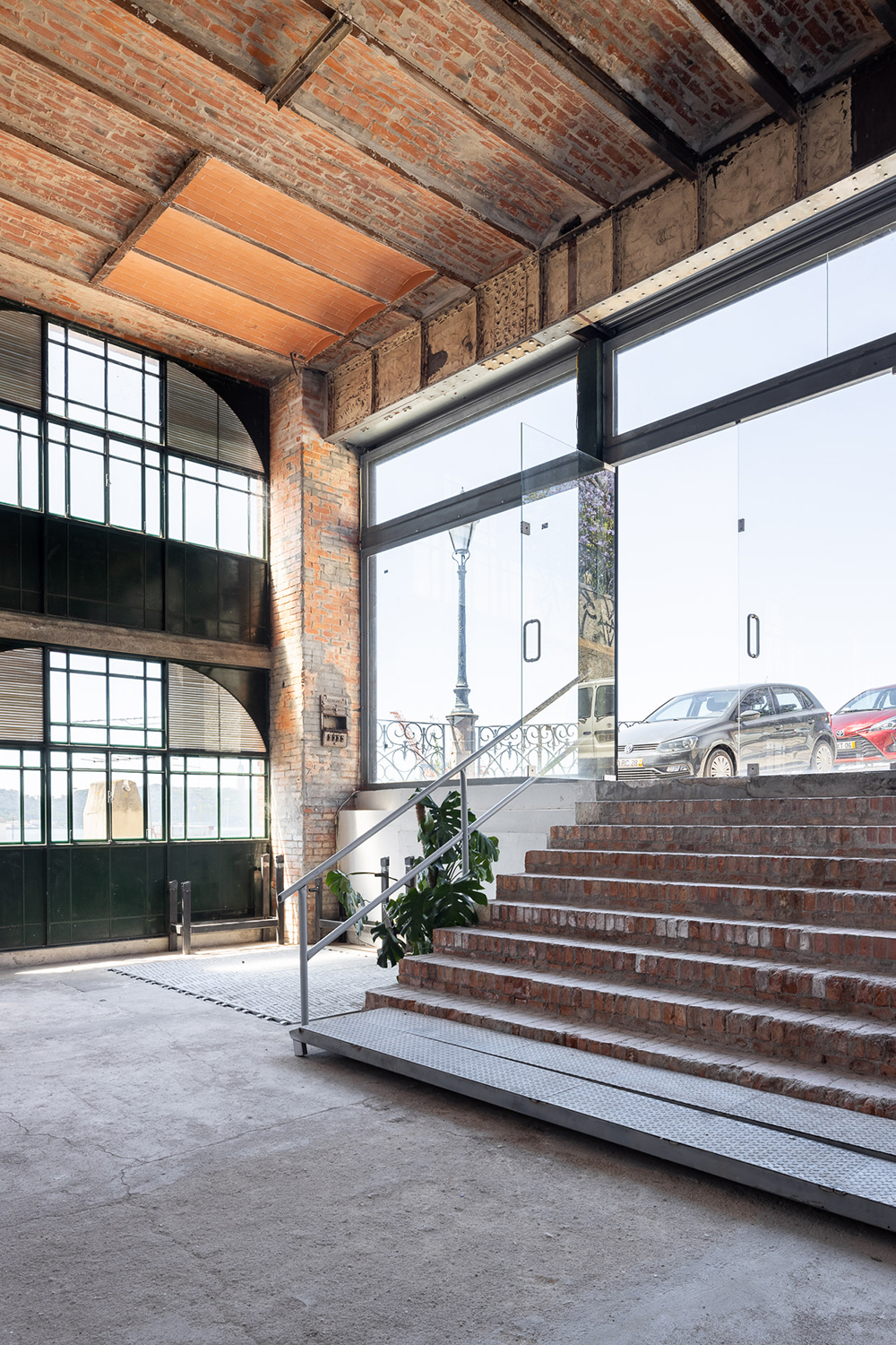 The warehouse is slightly sunken into the ground-floor level, and is accessed by brick stairs from streel level