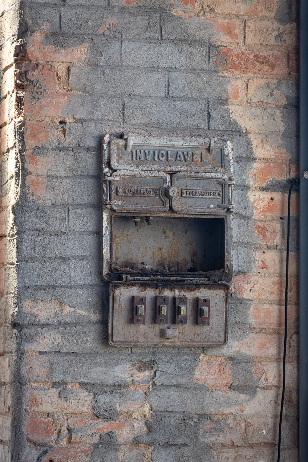 A close up of an old fuse box from the vacant building's factory dats