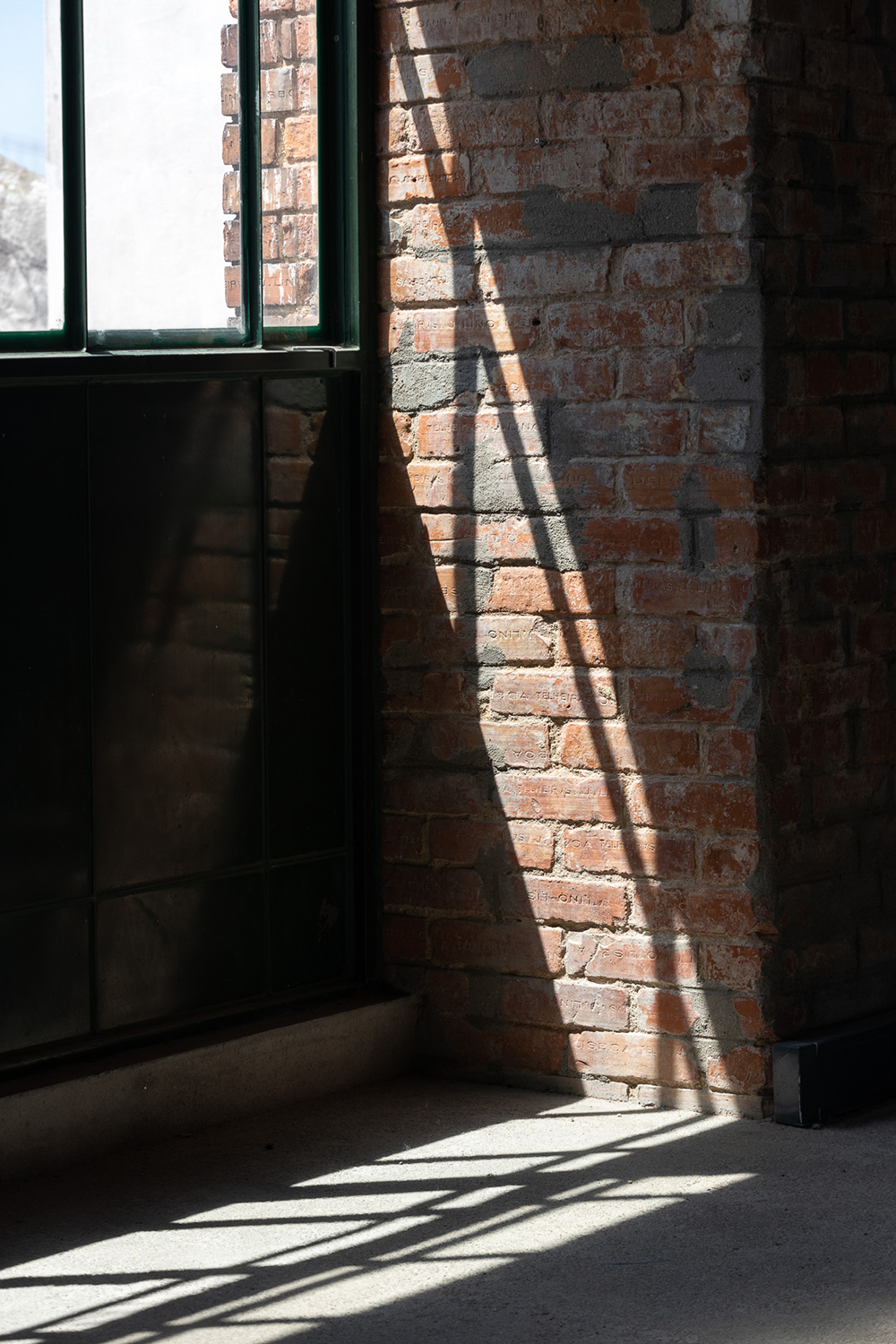 Light streams through the double-row of arched iron windows