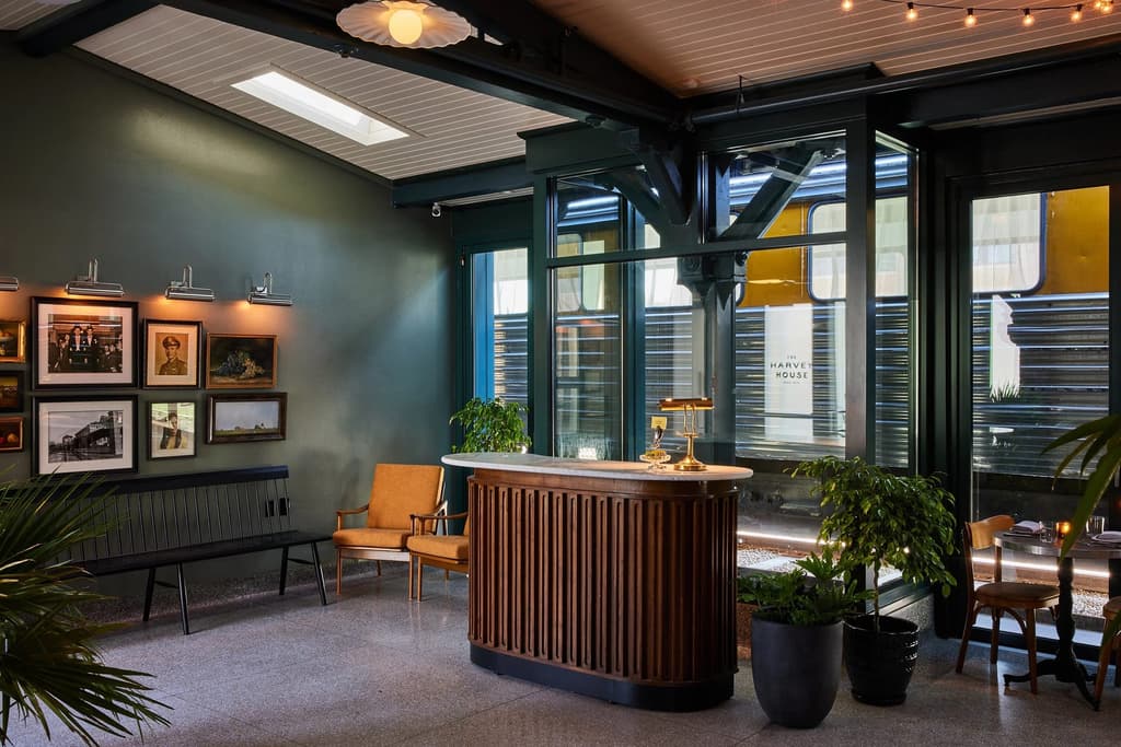 The colour palette reflects the golden age of the railway, with dark woods and heritage green shades