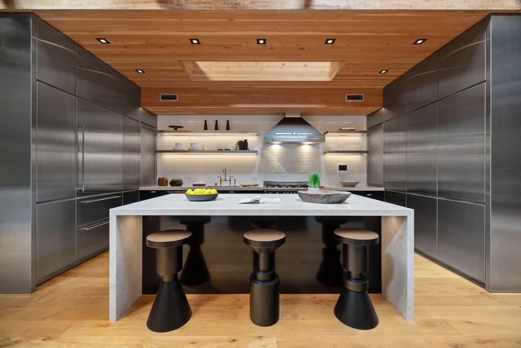 Stainless steel appliances and marble countertops in the kitchen