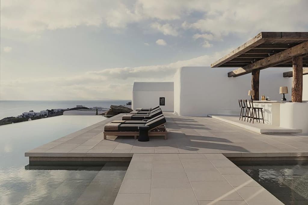The rustic minimalism of Kalesma, Mykonos blends cycladic design with clean lines, concrete and reflective pools