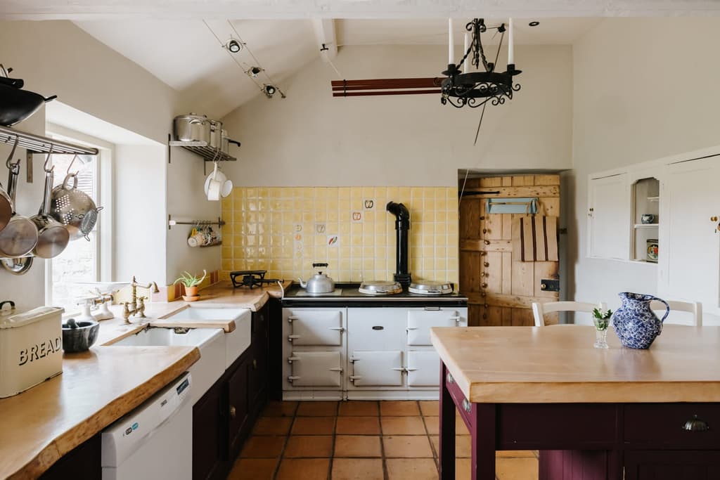 The kitchen has an old aga, wooden work tops and a serving hatch that connects to the dining room