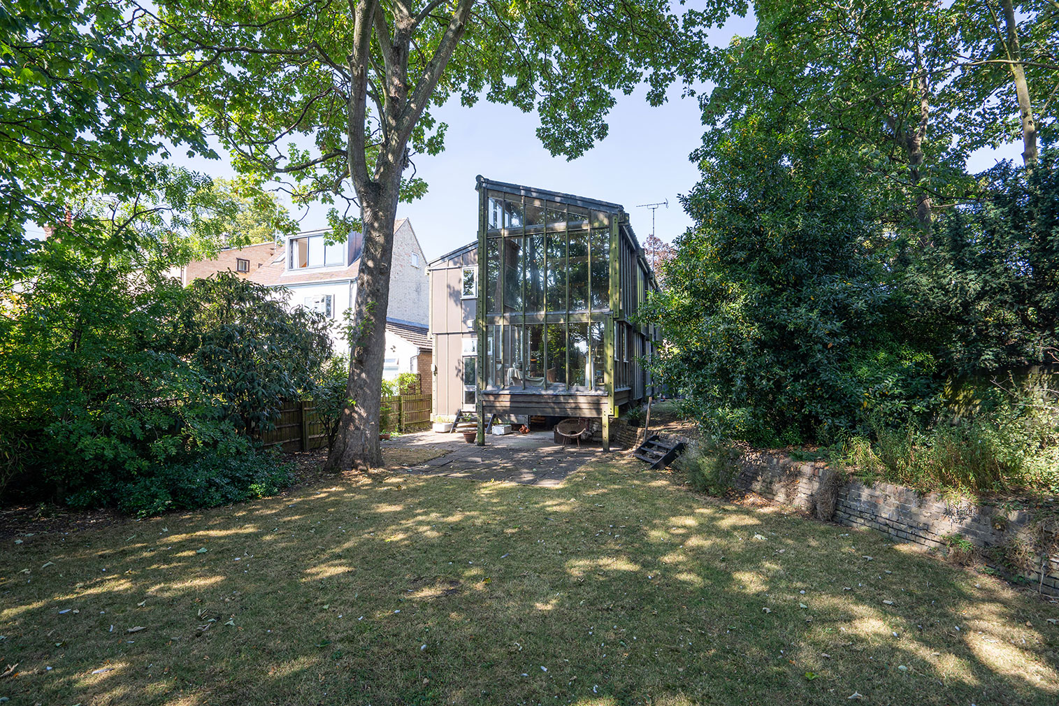 The Grade II-listed Cambridge property features a vaulted hall space with a glass-encased end wall which envelopes it in light and natural views.