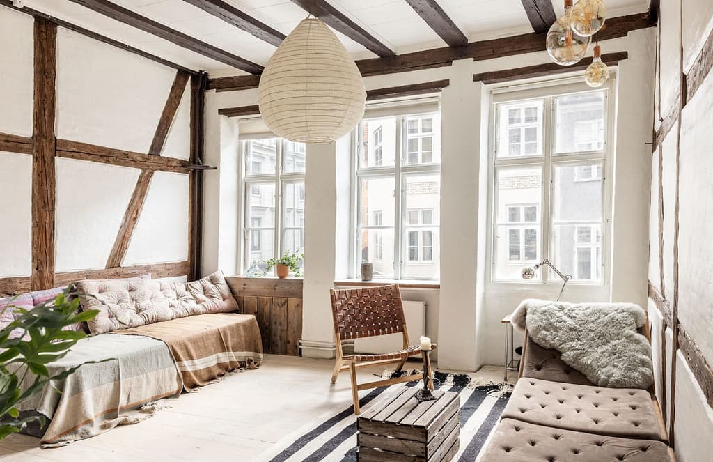 Peek inside a tiny Copenhagen loft with timbered ceilings and walls