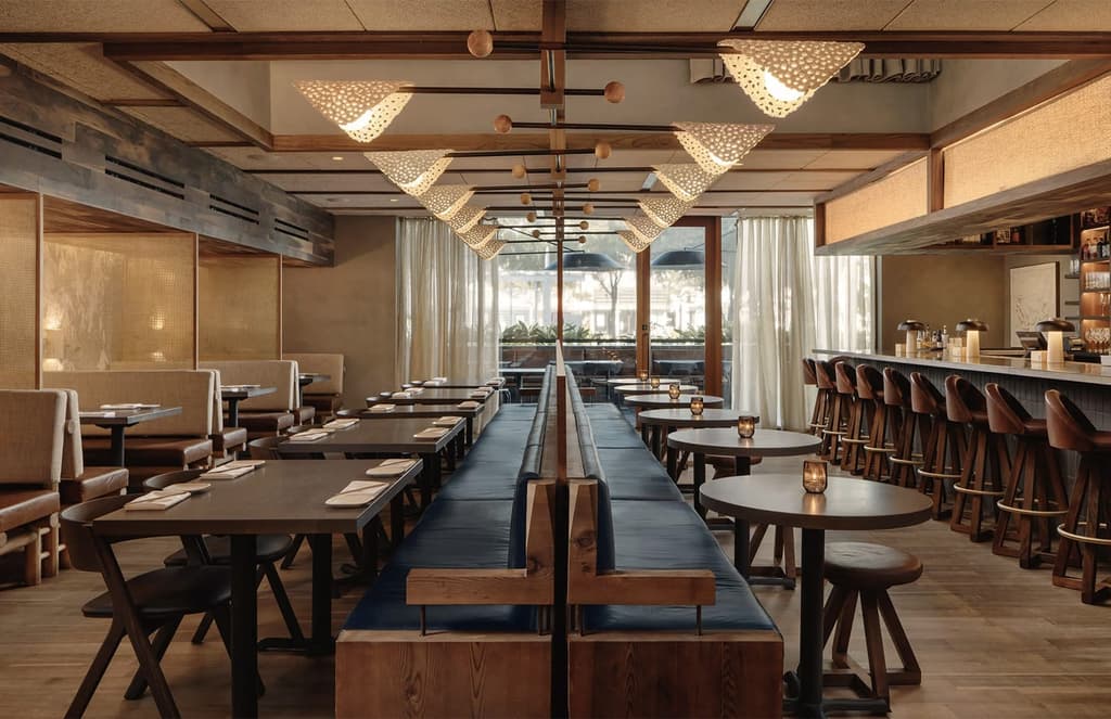 Uchiko Houston’s walnut interiors and sunken hearth evoke the warmth of a Japanese farmhouse