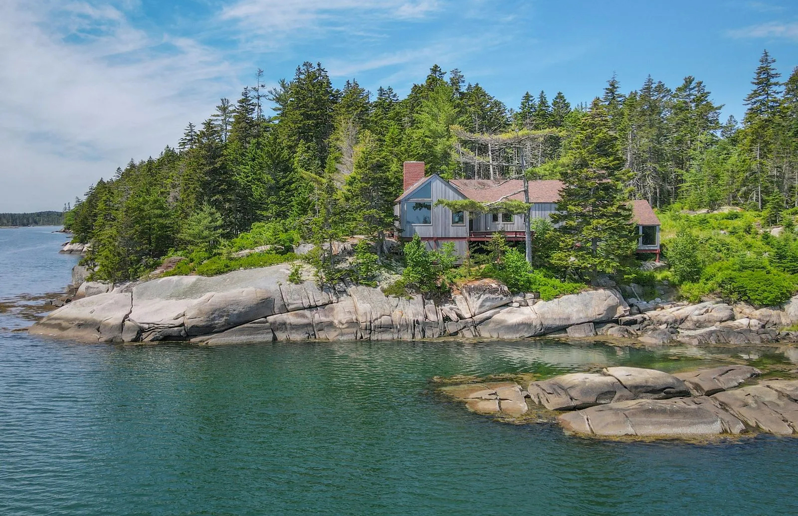 This all-season ocean-front home began life as a mid-century cabin