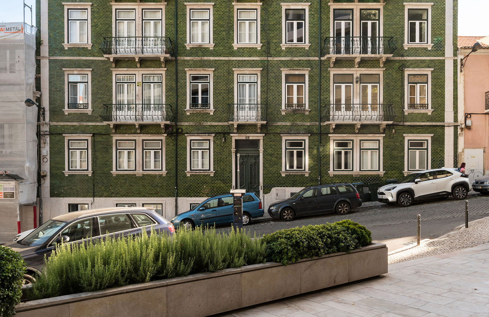 A glossy green facade sets the scene at this Lisbon home