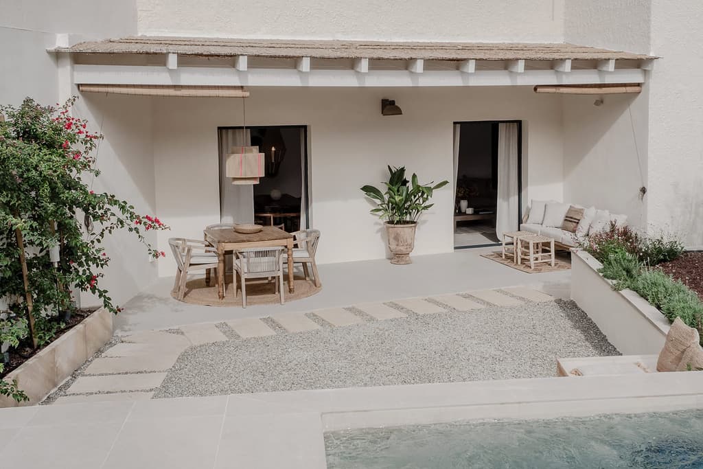 There's an al fresco dining area off the living room, which is accessed via sliding glass doors. The terrace is shaded by overhanging eaves