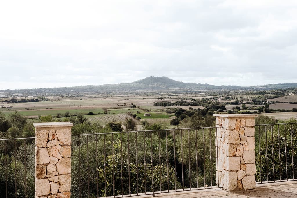 The home is wrapped in expansive countryside with verdant views of the Mallorcan landscape