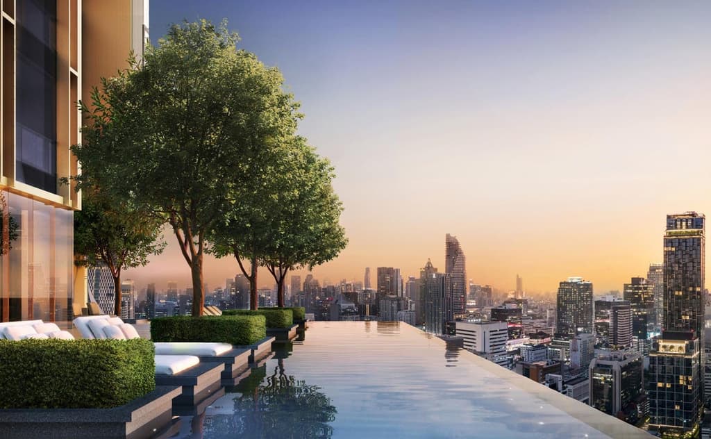 An infinity pool and planting feature on the terrace of this suite, with views across Bangkok's financial district