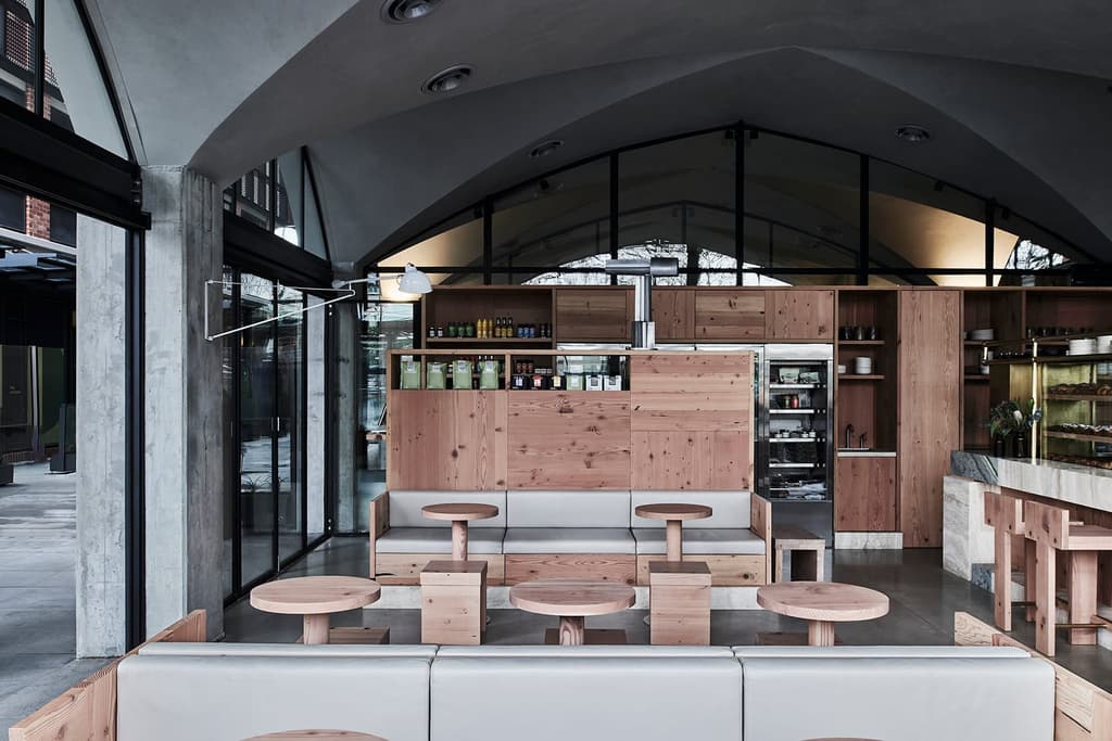 The concrete vaulted roof and raw timber funiture