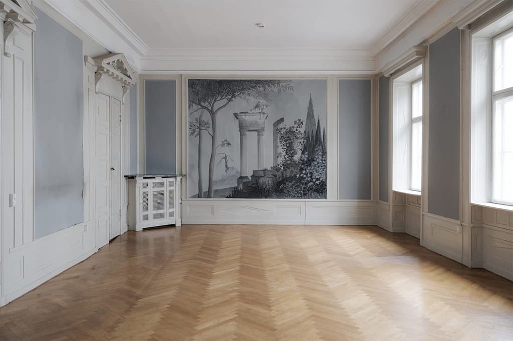 The reception room features a painted wall fresco