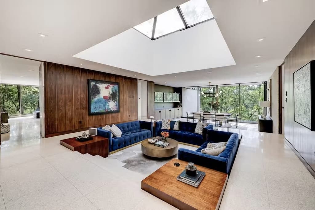 The living room features a conversation pit and huge roof light