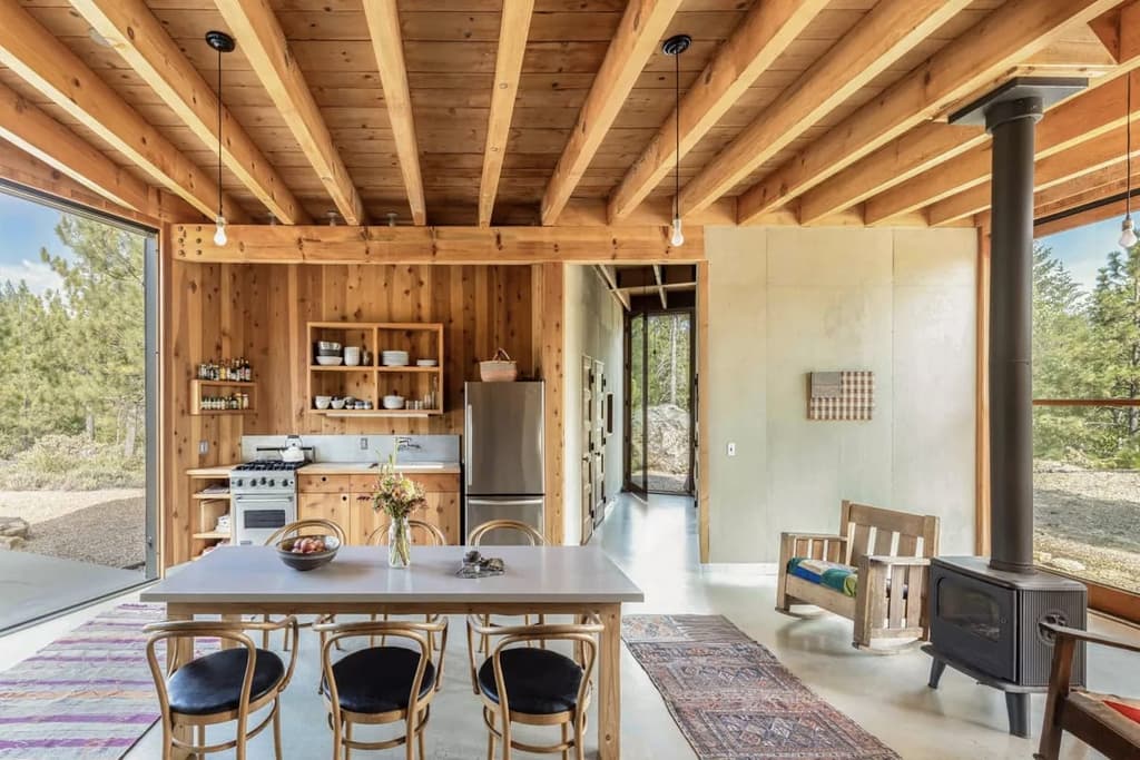 The Mountain House's dining room and kitchen. A wood burning stove heats the timber house