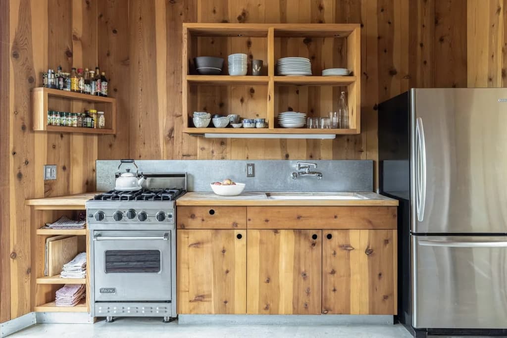 The kitchen, which features timber cabinetry and stainless steel appliances
