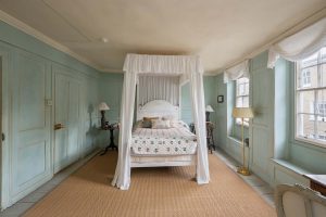 The primary bedroom has a four-poster bed