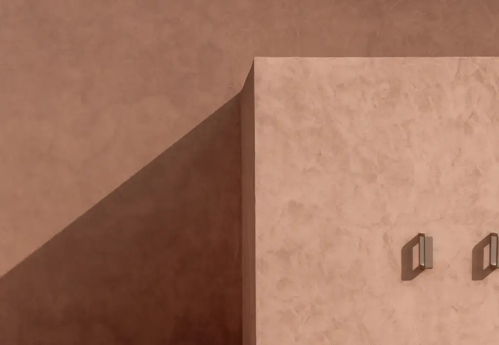 Dramatic shadows cast across the hotel's walls