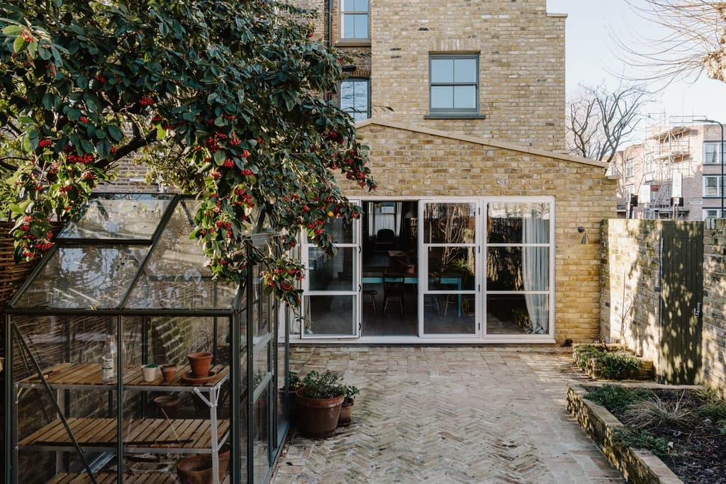 An exterior view of the rear of the property and its herringbone brick terrace