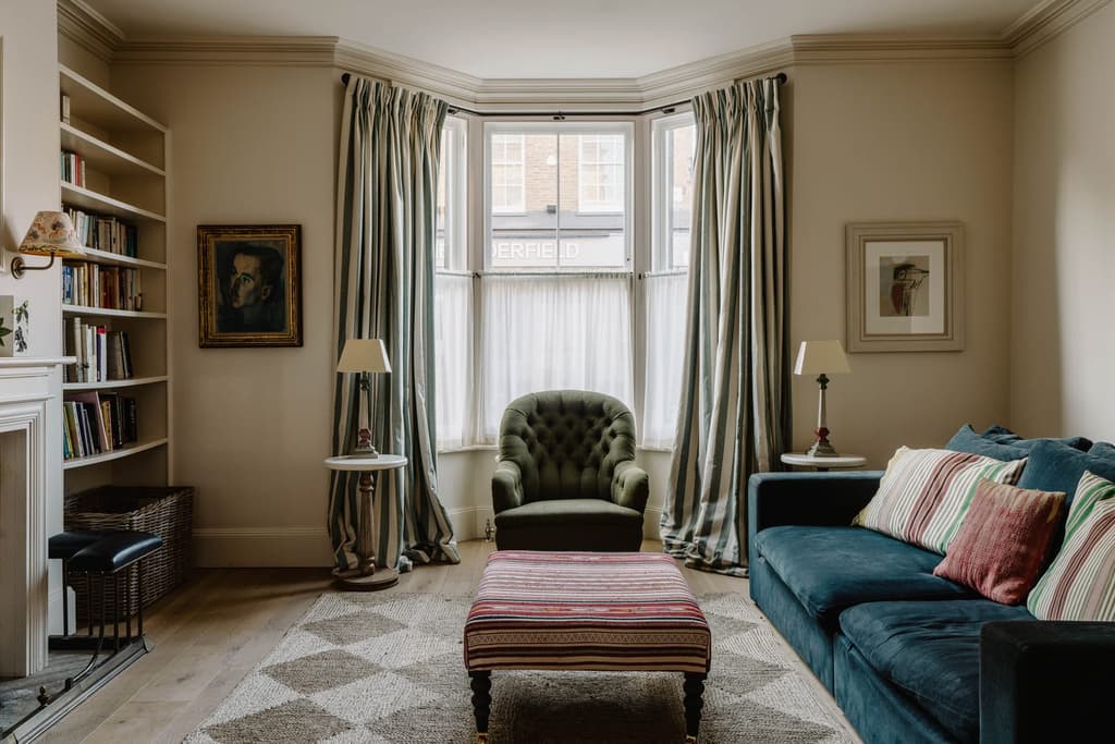 The living room, with bay window and period fireplace