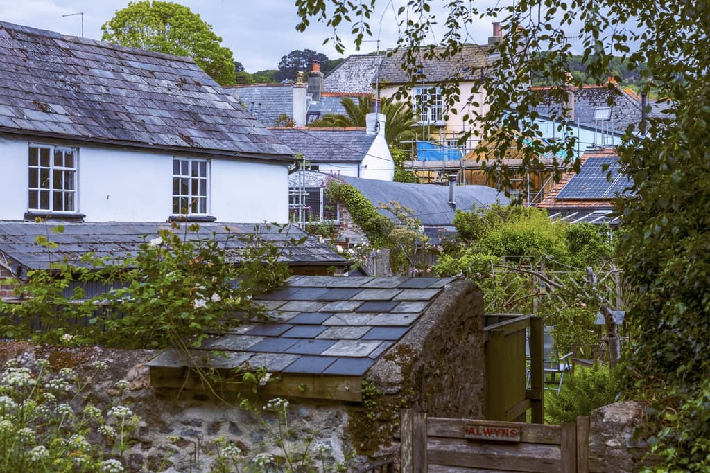 The building is on a lane plot, surrounded by houses and gardens