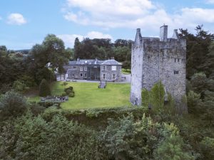 A view of the stone medieval tower and adjacent Georgian-period manor house