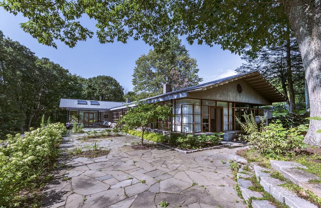 This refreshed Connecticut bungalow is drenched in light with leafy views