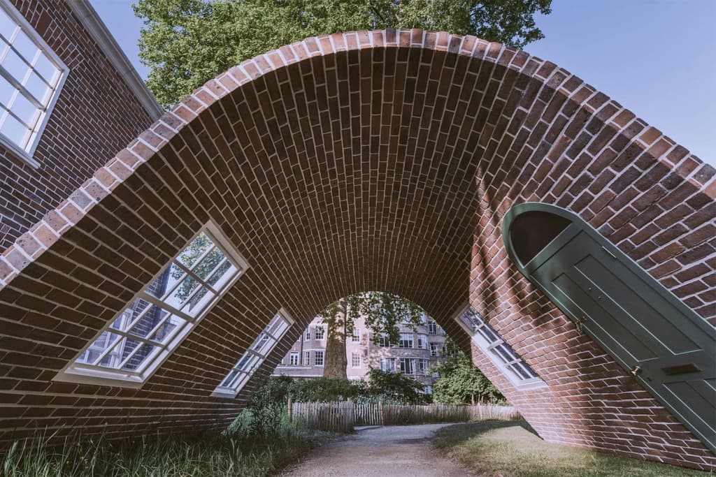 The sculpture forms a vaulted archway that visitors can walk beneath