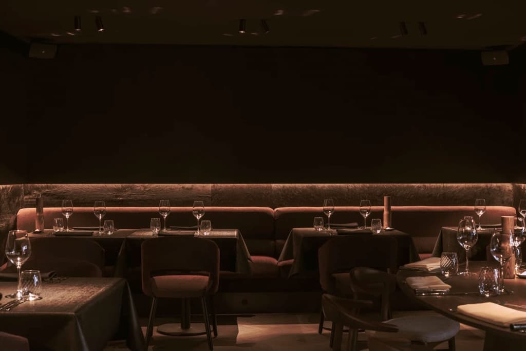 The dark and moody bar interior of restaurant Cult is designed to contrast the light-filled dining room