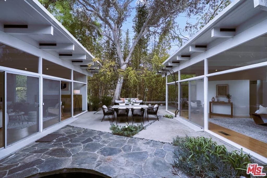 The house unravels around a central courtyard with a pond and fountain. Tall bamboo helps seclude the Brentwood property