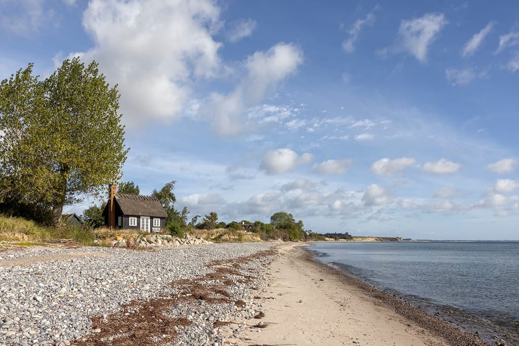 Buy a black timber summerhouse on the edge of the Baltic