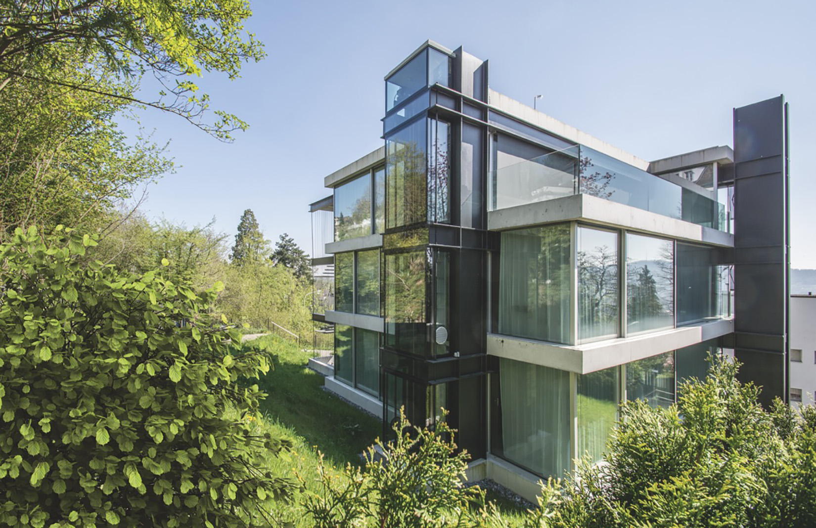 A radical hillside house suspends living space above residential Zurich