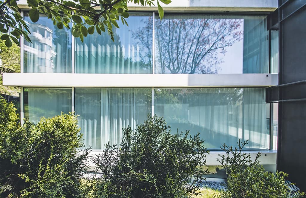 A radical hillside house suspends living space above residential