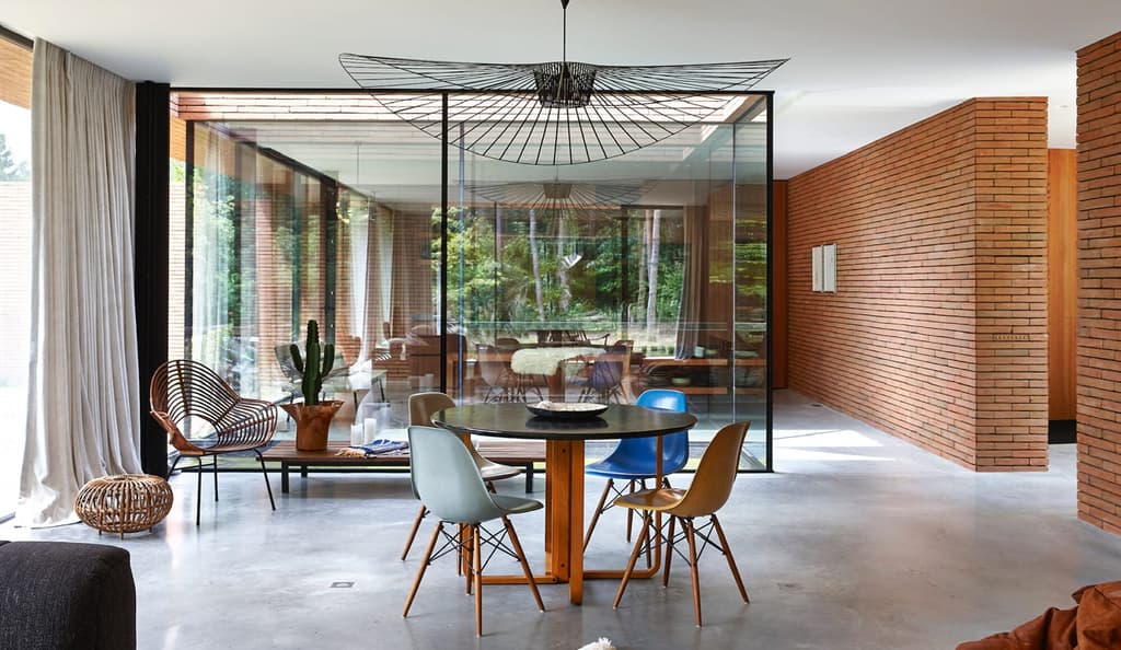 Wrapped in red brick, this contemporary villa withdraws into the forest