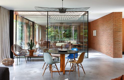 Wrapped in red brick, this contemporary villa withdraws into the forest