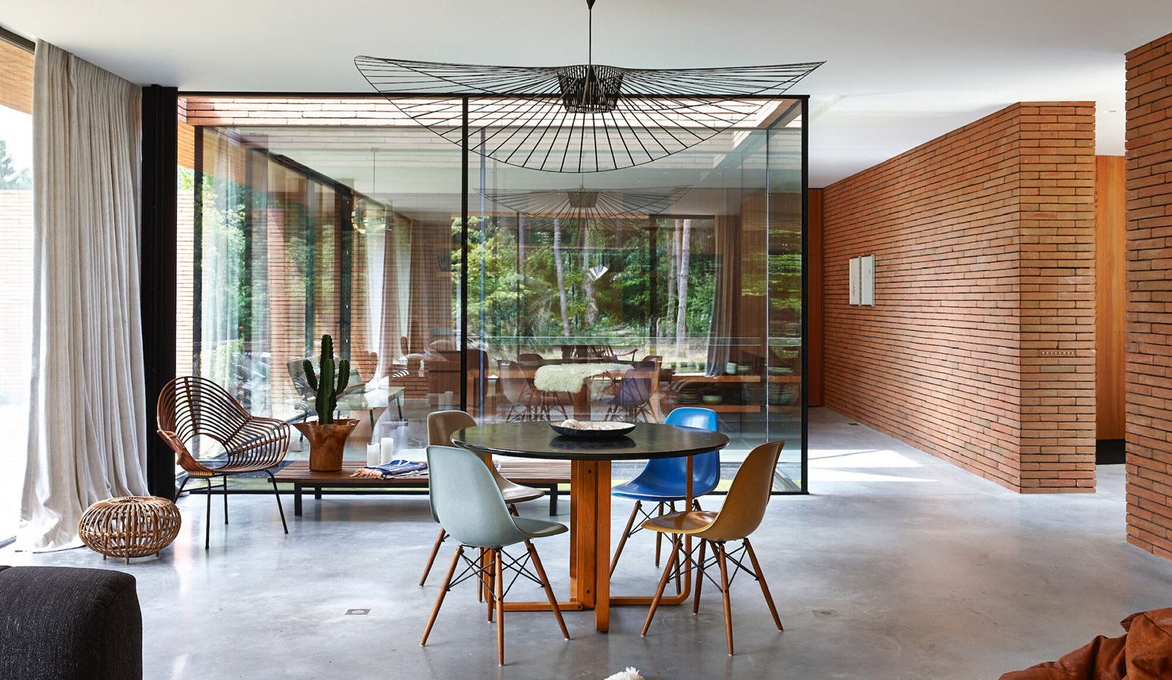 Wrapped in red brick, this contemporary villa withdraws into the forest