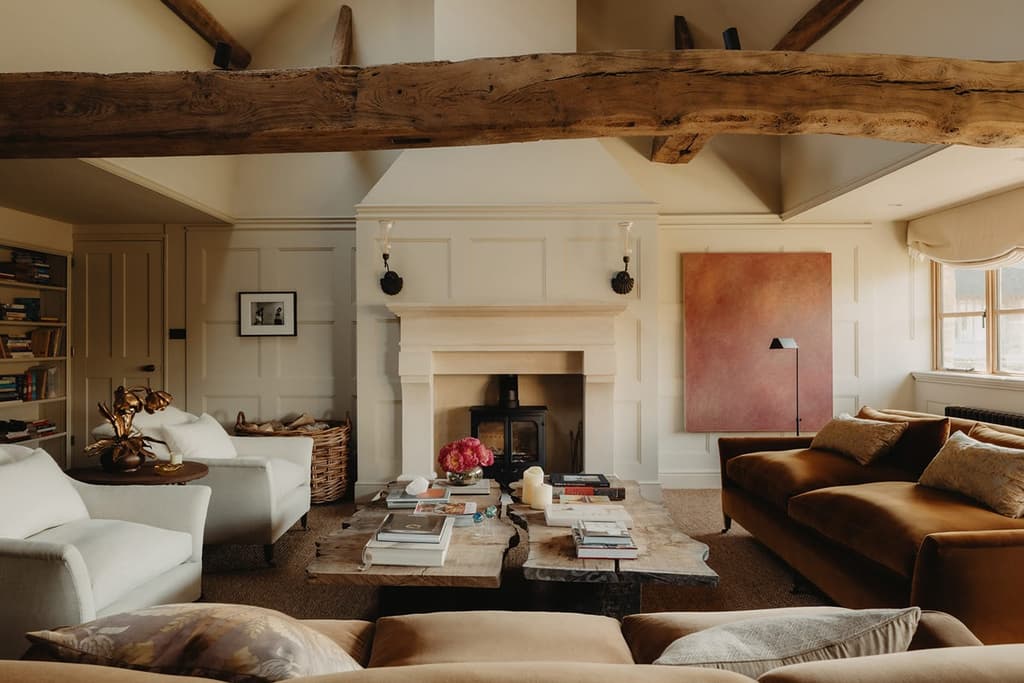 Exposed timber runs through this converted barn in the Cotswolds