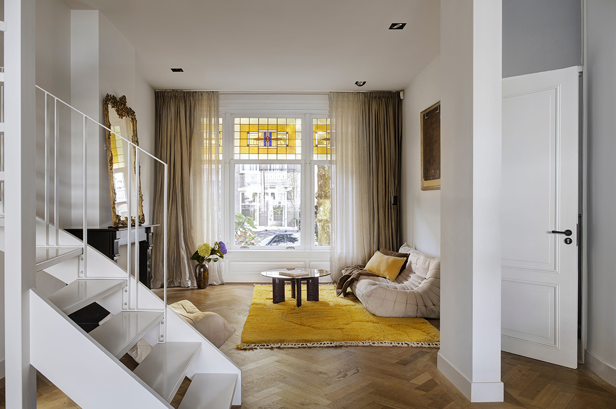 In east Amsterdam, a cool 20th-century townhouse is reworked with a wall of glass