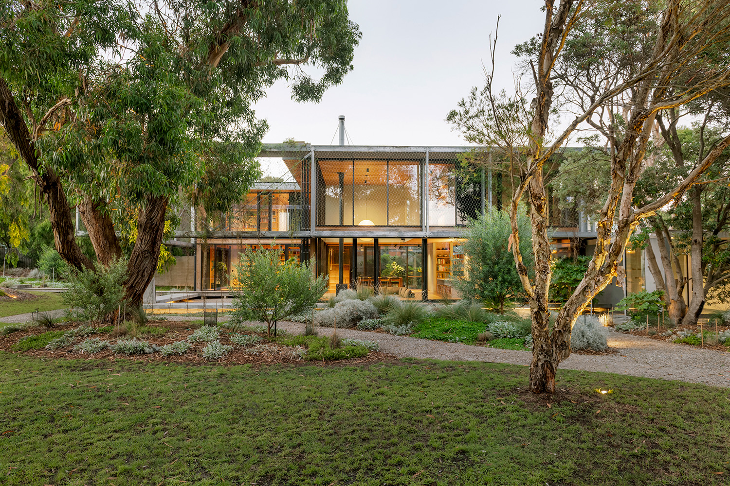 Hoisted among the treetops, an offbeat coastal hideaway opens to lush gardens