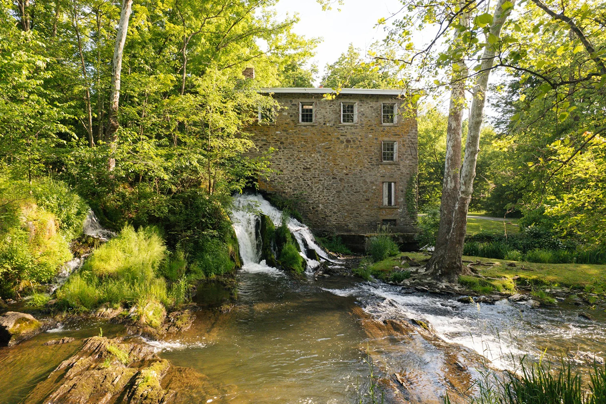A waterfall runs beneath this Hudson Valley mill